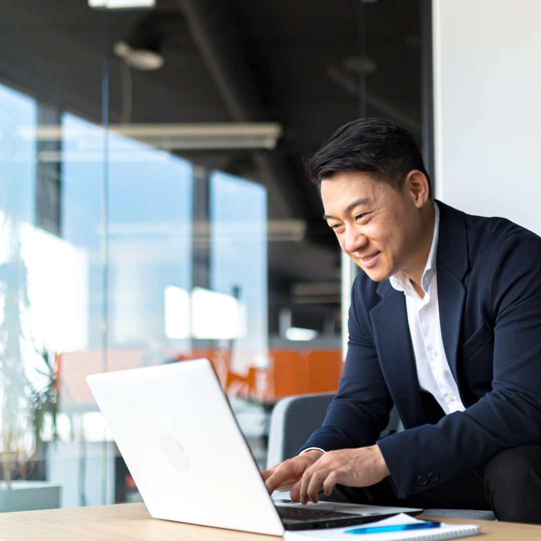 Business leader reviewing Q1 Business Readiness Playbook on his laptop to improve operational efficiency