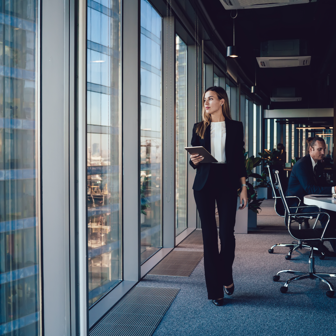 Business leader walking with a book reviewing Q1 technology systems to reduce inefficiencies